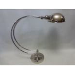 Nickel plated desk top lamp of curved form on circular base, approx 55cm high.