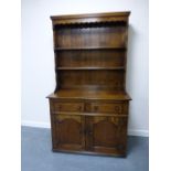 Brights of Nettlebed country oak dresser having boarded back with moulded cornice over shaped apron