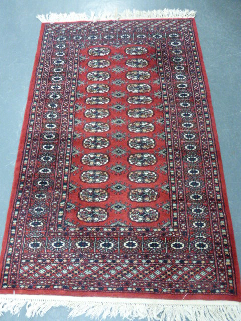 Iranian rug with two rows of twelve guls, 150x96cms.