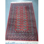 Iranian rug with two rows of twelve guls, 150x96cms.