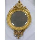 A 19th century giltwood framed wall mirror with scrolled shell crest with leaf and berry swags over