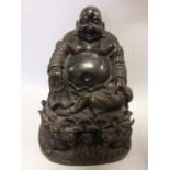 A cold cast bronze Buddha on cushion supported by a pair of dragons, 22cms in height.