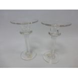 Pair of 19th century glass candlesticks with 9.5cm circular rims on a ringed tapering column and 7.