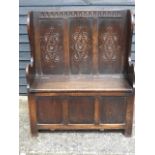 An 18th Century style carved solid oak settle, circa 1900-1920,