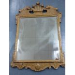 A 19th Century giltwood and gesso framed wall mirror with Fleur-de-Lys and Griffin pediment and