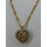 A 10ct gold and diamond heart shaped pendant with mother and child centre surrounded by 24 diamonds,