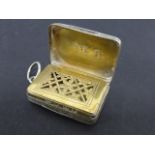 George III silver vinaigrette of rectangular form with engine turned decoration and foliate border,