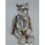 Carrs silver seated Teddy Bear of jointed form, hallmarked Sheffield 2004, 10.5cms in height.