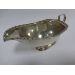 Silver sauce boat with beaded border, hallmarked Birmingham 1938 by maker S Blanckensee & Son, 104.
