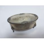 Silver oval trinket box with beaded shell border to hinged lid raised on four cabriole supports,