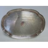 Silver petal shaped tray with engine turned decoration and vacant cartouche,