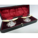 Cased pair of Ivory and silver mounted knife rests,