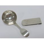 Sterling silver caddy spoon together with a Lunt sterling silver money clip with engraved Dollar