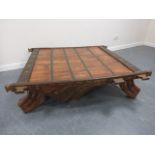 Large Chinese low table with iron and brass decoration, with shaped supports, 126x126x36cms.