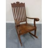 Profusely carved teak Rocking chair.