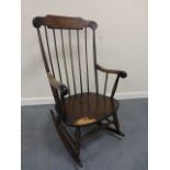 Oak rocking chair with turned supports.