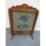 Early 20thC mahogany fire screen with inlaid satinwood paterae and embroidered tapestry behind