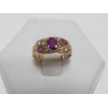 An Edwardian 9ct gold Ruby and seed pearl ring (one pearl missing) hallmarked Chester 1907,