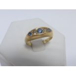 An 18ct gold five stone Sapphire and Diamond ring, hallmarked Birmingham 1915, size N.