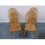 Set of four pine wheel back chairs.