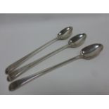 Three Georgian silver serving spoons, 30.5cms in length, hallmarks rubbed, makers initials TC, 352g.