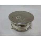 Silver circular lidded trinket box with engine turned hinged lid decorated with flowers,