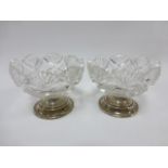 A pair of silver mounted cut glass salts hallmarked Birmingham 1911 by makers G E Walton & Co Ltd,