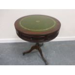 Mahogany drum table with two concealed drawers and inset leatherette top,