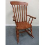 Stained rocking chair with turn supports.