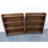 Pair of oak waterfall bookcases, each with four shelves, each 76cms in length.