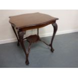 Early 20thC mahogany occasional table with shaped top and carved cabriole supports united by