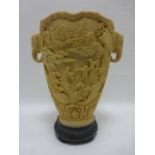 Chinese faux ivory vase with twin elephant head handles, raised on circular plinth, 31cm high.