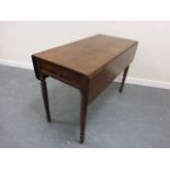 A 19thC mahogany Pembroke table with D-shaped leaves, long frieze drawer and dummy drawer to verso,