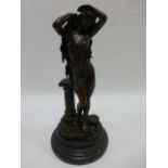 Cast Bronze of semi-clad woman with long hair, raised on circular marbled base, 30cm high.