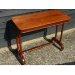 Victorian mahogany side table on side supports united by stretcher, on castors, 92x44x72cms.