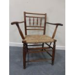 A 19thC oak splayed open armchair with s