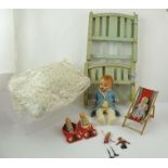 A DOLL'S COT, with linen and various dolls