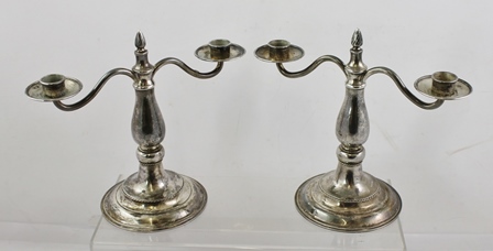 GUILD OF HANDICRAFT A PAIR OF WROUGHT SILVER TWO-BRANCH CANDELABRUM, each with a central fixed flame