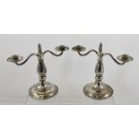 GUILD OF HANDICRAFT A PAIR OF WROUGHT SILVER TWO-BRANCH CANDELABRUM, each with a central fixed flame