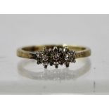 A DIAMOND FLORAL CLUSTER RING having nine 8/8 cut diamonds in 9ct gold claw setting, size J