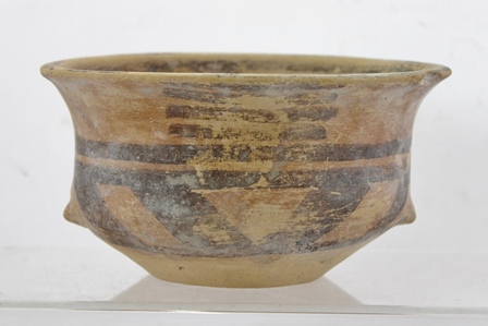 A PROBABLY NEOLITHIC DOUBLE HANDLED BOWL with scrolling decoration, approximately 15cm diameter
