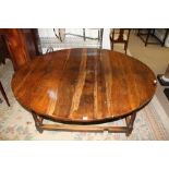 A PART 18TH CENTURY OAK DINING TABLE with oval top raised on ring turned column supports with