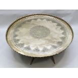 A MID 20TH CENTURY OVERSIZED BRASS TRAY TOPPED COFFEE TABLE with embossed central flower head