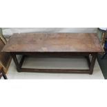 AN 18TH CENTURY OAK REFECTORY TABLE, having plank top over chamfered supports and plain