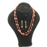 A 1920's CARVED CORAL SAUTOIR WITH MATCHING DROP EARRINGS, 118cm long