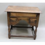 A GEORGE III OAK LOWBOY, fitted one long drawer over two short drawers either side of a shaped