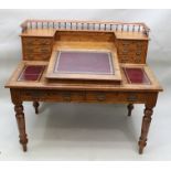 A LATE 19TH CENTURY PITCH PINE "DICKENS" DESK, having gallery back over banks of small drawers,