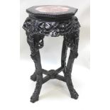 A 20TH CENTURY CHINESE CARVED HARDWOOD PLANT STAND, with insert octagonal rouge marble top, over