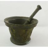 AN EARLY BRONZE PESTLE AND MORTAR with Grecian decoration, mortar 14cm diameter
