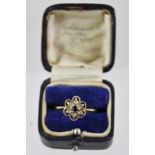 A 9CT GOLD DRESS RING having sapphire centre and spinels around in a floral head, size O1/2